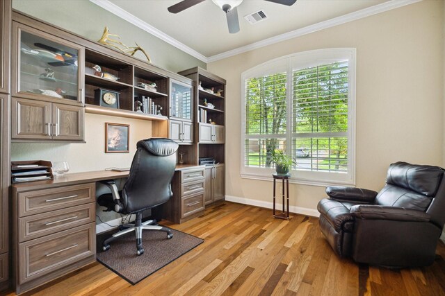 office with ceiling fan, visible vents, ornamental molding, and built in desk