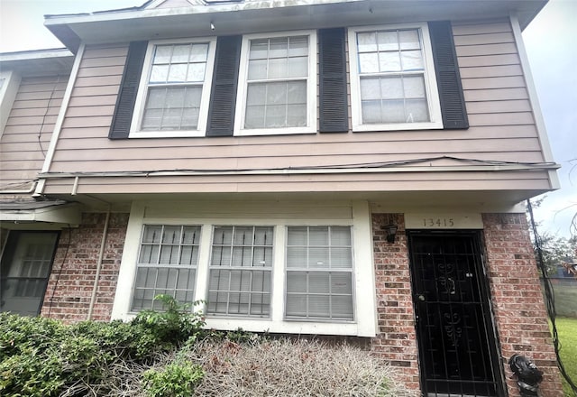 exterior space with brick siding