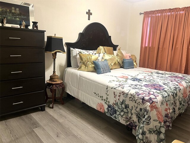 bedroom featuring wood finished floors