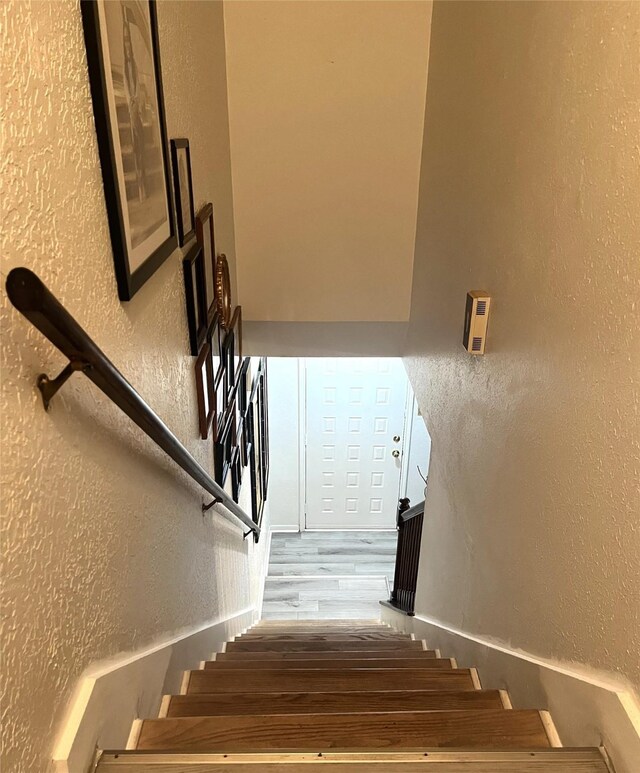 stairs featuring a textured wall