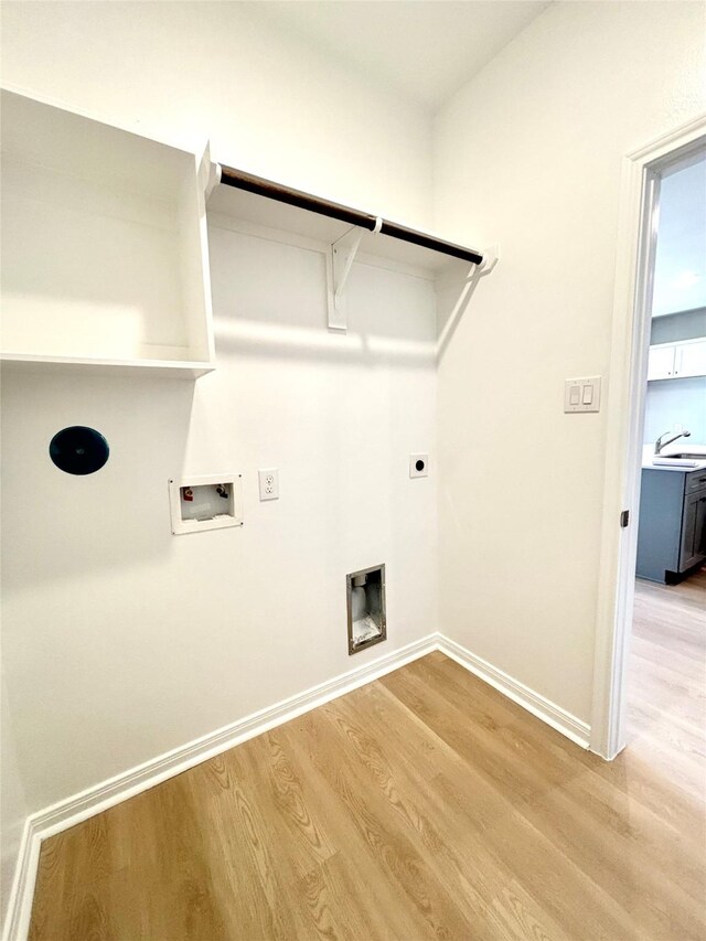 laundry room with baseboards, laundry area, light wood finished floors, and hookup for a washing machine