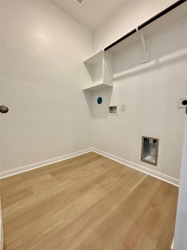 laundry room with washer hookup, laundry area, electric dryer hookup, light wood-type flooring, and baseboards