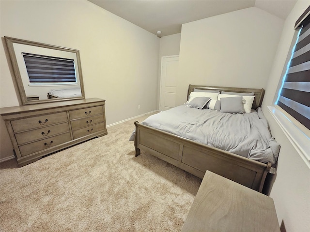 bedroom featuring carpet floors, baseboards, and vaulted ceiling