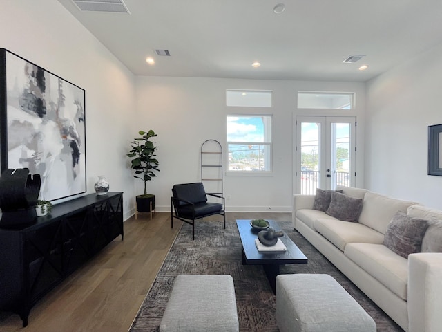 living area featuring recessed lighting, visible vents, and wood finished floors