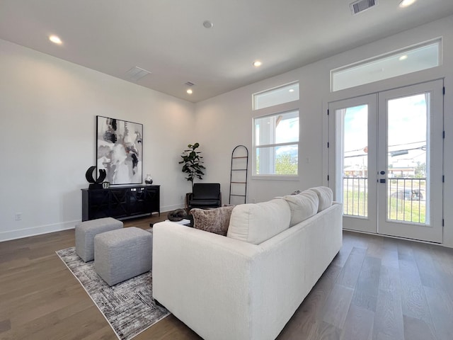 living room with visible vents, recessed lighting, wood finished floors, and french doors