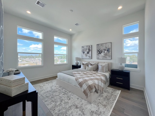 bedroom featuring recessed lighting, baseboards, visible vents, and multiple windows