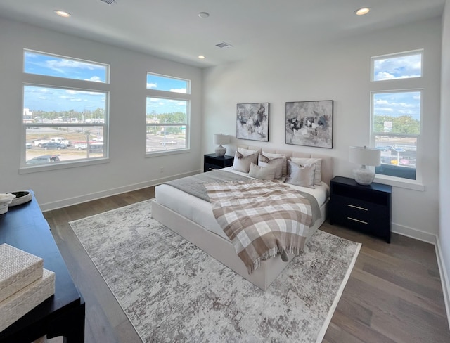 bedroom with dark wood finished floors, baseboards, and recessed lighting