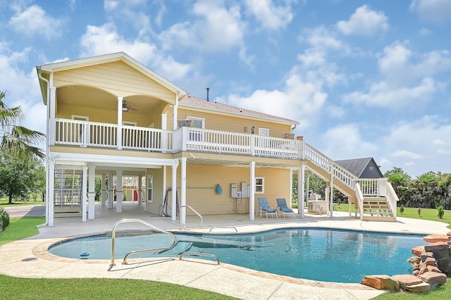1004 8th St, San Leon, TX 77539 - rear view of house with stairs, a patio, a ceiling fan, and an outdoor pool