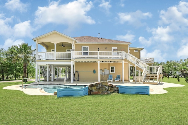 1004 8th St, San Leon, TX 77539 - rear view of house featuring a patio area, a lawn, ceiling fan, and stairs