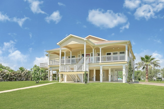 1004 8th St, San Leon, TX 77539 - back of house with a porch, stairs, a carport, and a lawn