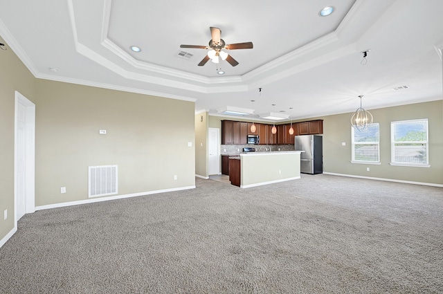 1004 8th St, San Leon, TX 77539 - unfurnished living room featuring a raised ceiling, light carpet, visible vents, and ceiling fan with notable chandelier