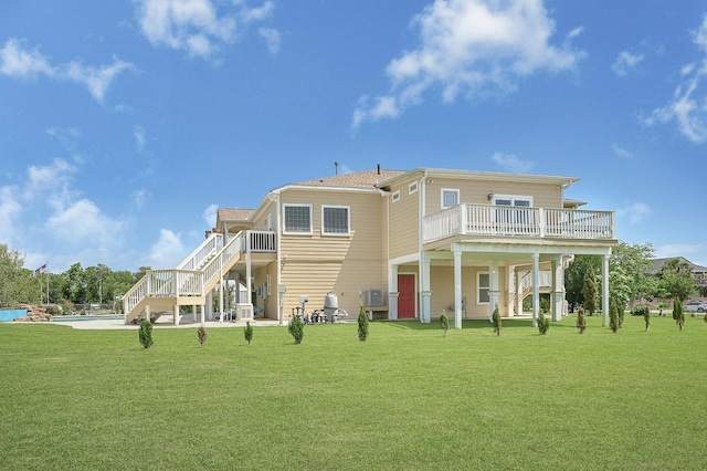 1004 8th St, San Leon, TX 77539 - rear view of house with a yard, a deck, stairway, and an outdoor pool