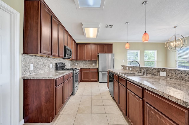 1004 8th St, San Leon, TX 77539 - kitchen featuring hanging light fixtures, light tile patterned flooring, a sink, decorative backsplash, and stainless steel appliances