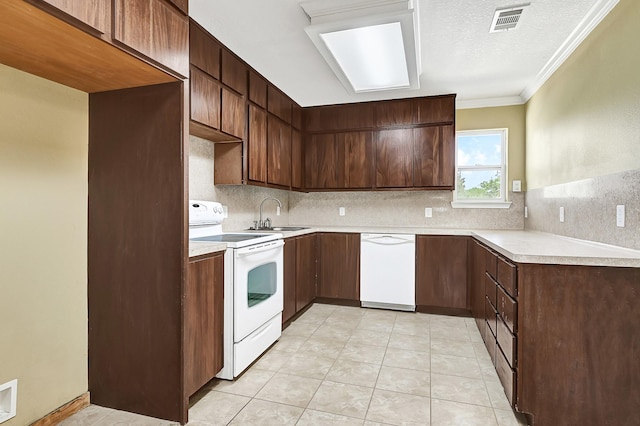 1004 8th St, San Leon, TX 77539 - kitchen featuring white appliances, visible vents, a sink, decorative backsplash, and light countertops