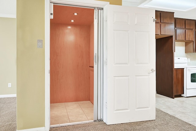 1004 8th St, San Leon, TX 77539 - interior space featuring light colored carpet, elevator, light tile patterned floors, and baseboards