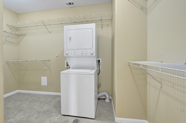 1004 8th St, San Leon, TX 77539 - laundry area featuring baseboards, stacked washer and dryer, laundry area, and visible vents
