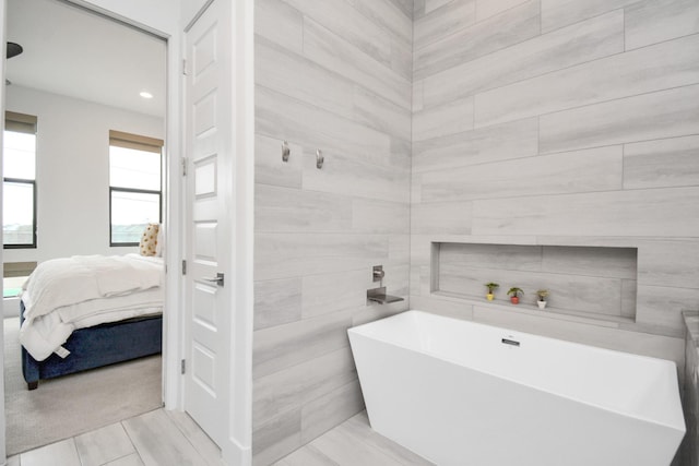 ensuite bathroom featuring a soaking tub