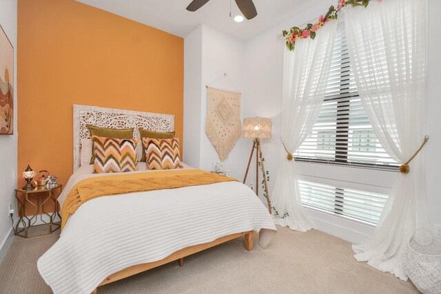 carpeted bedroom featuring a ceiling fan and baseboards