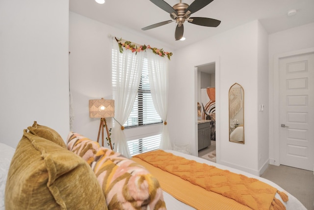 bedroom featuring multiple windows, light colored carpet, ensuite bathroom, ceiling fan, and recessed lighting