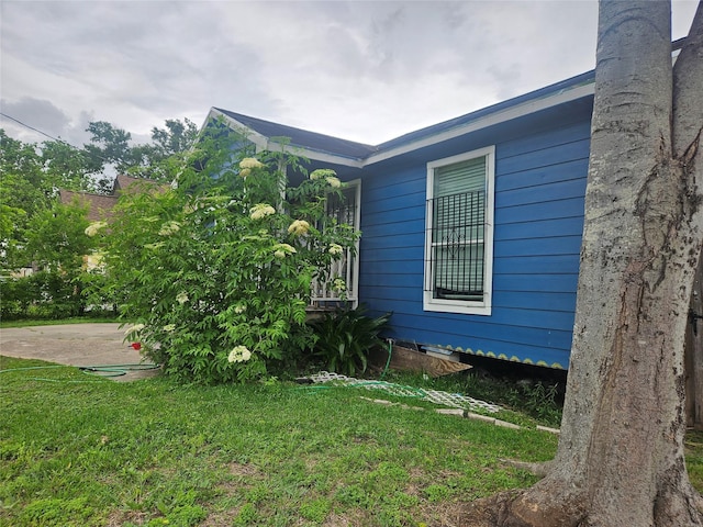 view of property exterior with a yard