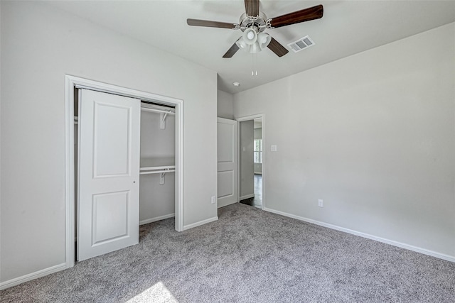 unfurnished bedroom with ceiling fan, visible vents, carpet floors, baseboards, and a closet