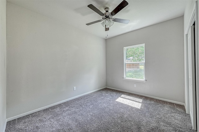 unfurnished bedroom featuring baseboards, carpet flooring, a ceiling fan, and a closet