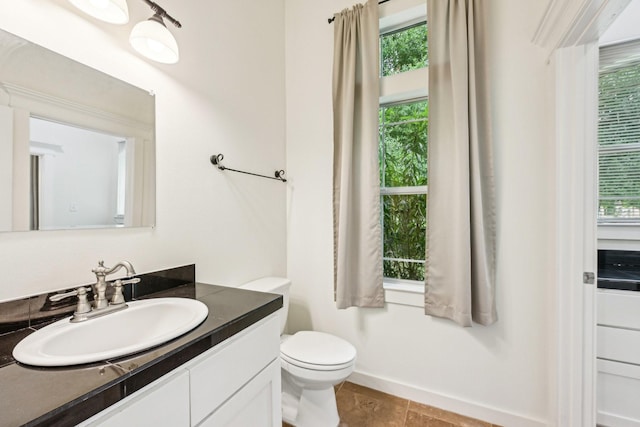 12061 Oak Forest Ln, Conroe, TX 77385 - bathroom with vanity, toilet, and baseboards
