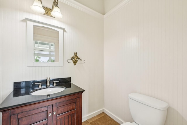bathroom with vanity, baseboards, and toilet