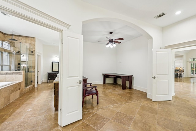 hall with recessed lighting, baseboards, arched walkways, and visible vents