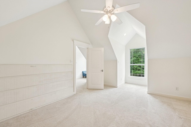 additional living space featuring carpet floors, baseboards, ceiling fan, and lofted ceiling