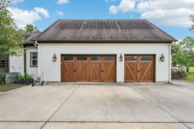 12061 Oak Forest Ln, Conroe, TX 77385 - garage with concrete driveway and cooling unit