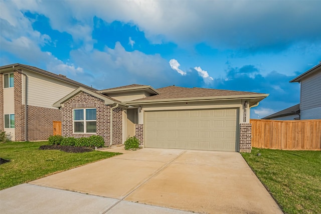 view of front of home featuring brick siding, an attached garage, fence, and a front lawn