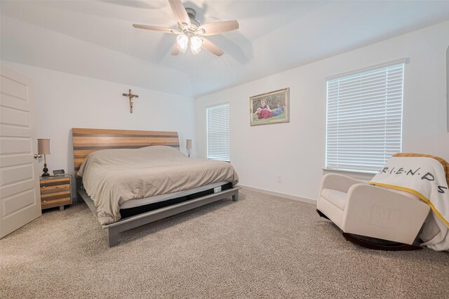 carpeted bedroom with a ceiling fan and baseboards