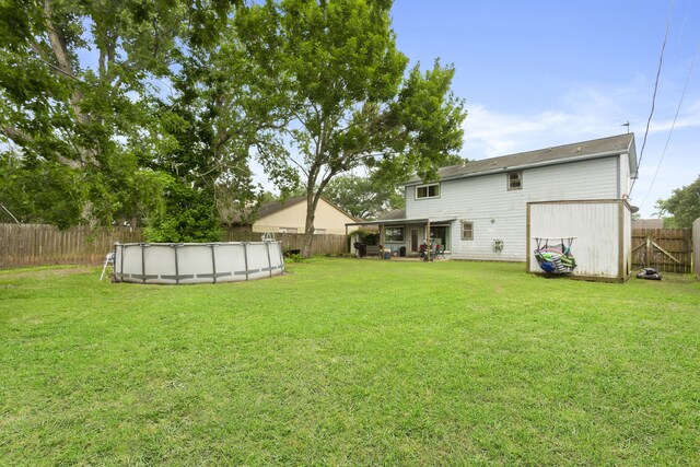 view of yard with a fenced backyard and a fenced in pool