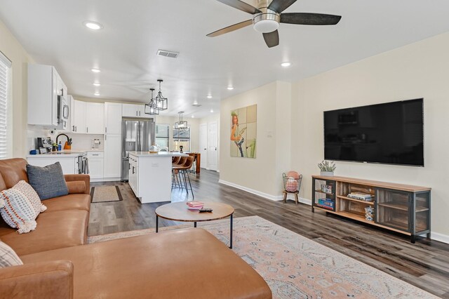 1747 Forest Hill Blvd, Houston, TX 77023 - living room with dark wood-style flooring, ceiling fan, baseboards, and recessed lighting