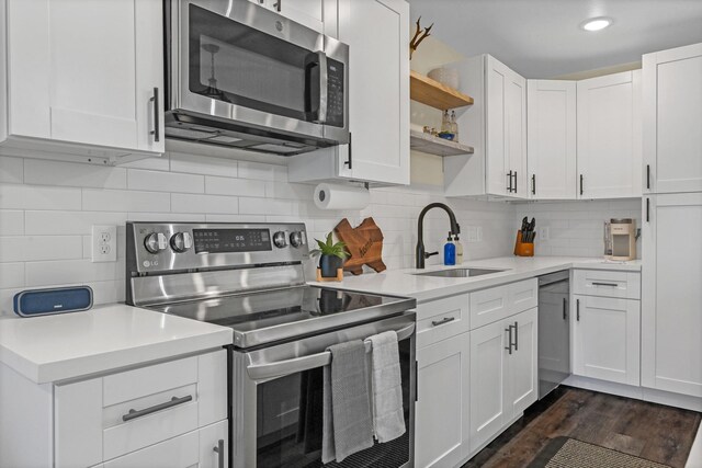1747 Forest Hill Blvd, Houston, TX 77023 - kitchen featuring stainless steel appliances, a sink, open shelves, light countertops, and white cabinets