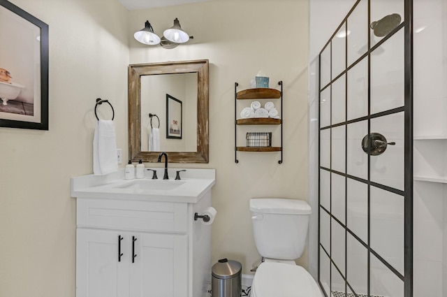 full bathroom with a tile shower, vanity, and toilet
