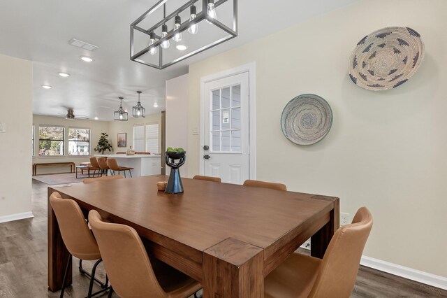 1747 Forest Hill Blvd, Houston, TX 77023 - dining area featuring dark wood-type flooring, baseboards, recessed lighting, ceiling fan, and a chandelier