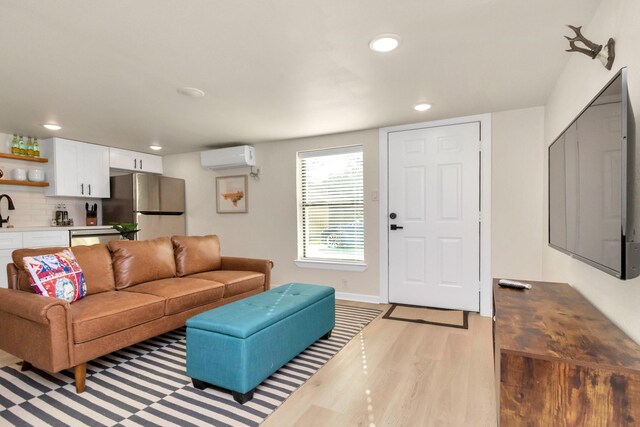 1747 Forest Hill Blvd, Houston, TX 77023 - living room featuring a wall mounted AC, light wood-style flooring, and recessed lighting