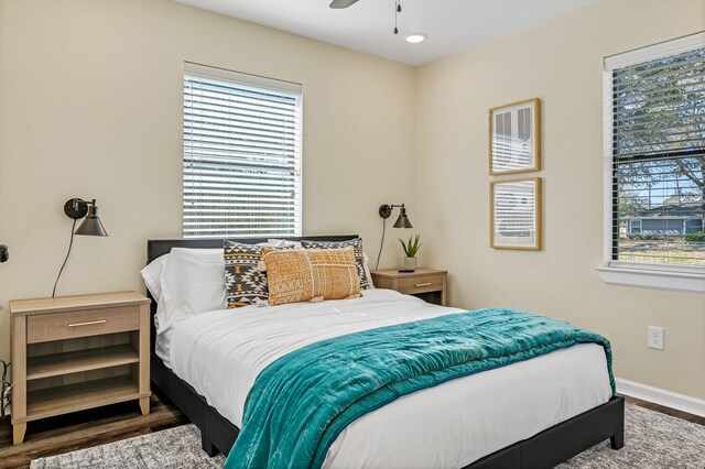 1747 Forest Hill Blvd, Houston, TX 77023 - bedroom featuring wood finished floors, multiple windows, baseboards, and ceiling fan