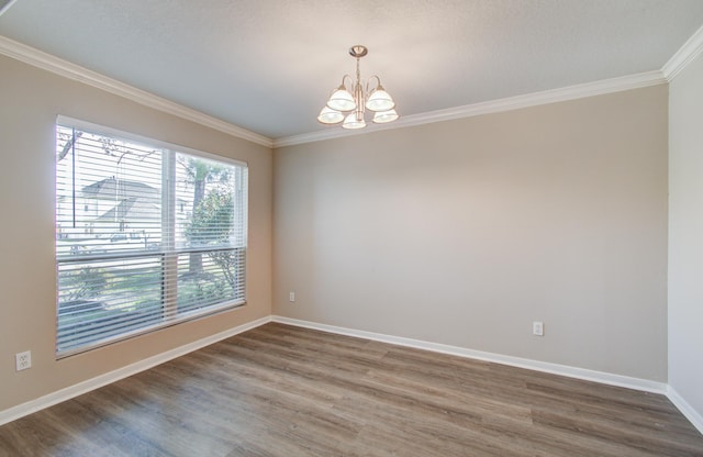 1211 Reedpoint Dr, Houston, TX 77090 - unfurnished room featuring ornamental molding, wood finished floors, and a notable chandelier