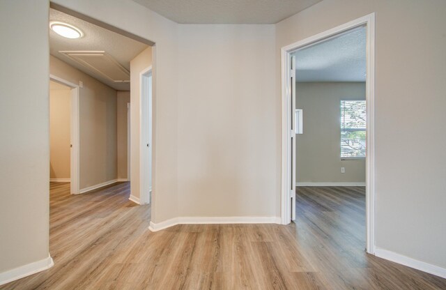 1211 Reedpoint Dr, Houston, TX 77090 - hall featuring baseboards, a textured ceiling, and wood finished floors