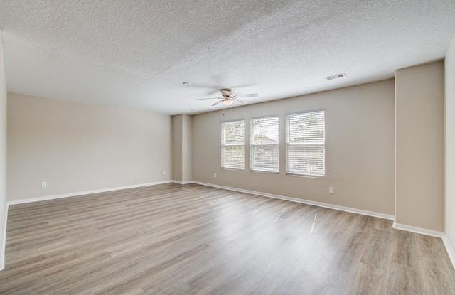 1211 Reedpoint Dr, Houston, TX 77090 - empty room featuring baseboards, a ceiling fan, light wood-style flooring, and a textured ceiling