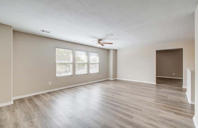 1211 Reedpoint Dr, Houston, TX 77090 - unfurnished room with light wood-style floors, ceiling fan, a textured ceiling, and visible vents
