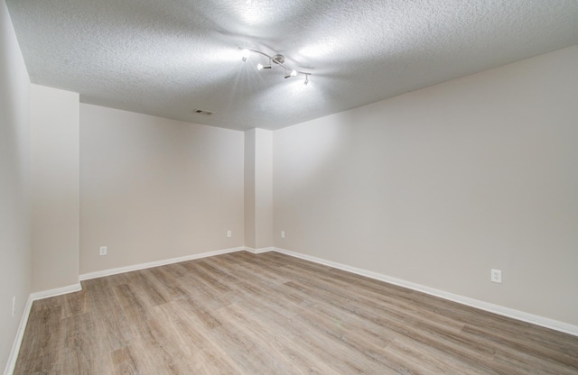 1211 Reedpoint Dr, Houston, TX 77090 - unfurnished room featuring baseboards, light wood-style flooring, a textured ceiling, and visible vents