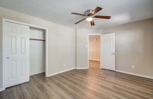 1211 Reedpoint Dr, Houston, TX 77090 - unfurnished bedroom featuring baseboards, ceiling fan, light wood finished floors, and a closet