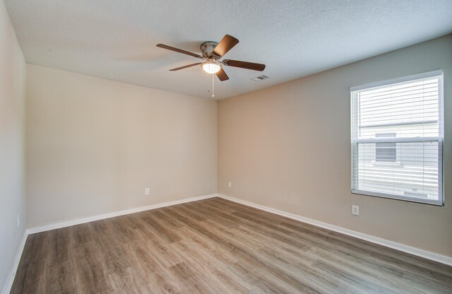 1211 Reedpoint Dr, Houston, TX 77090 - unfurnished room with ceiling fan, baseboards, and light wood-type flooring