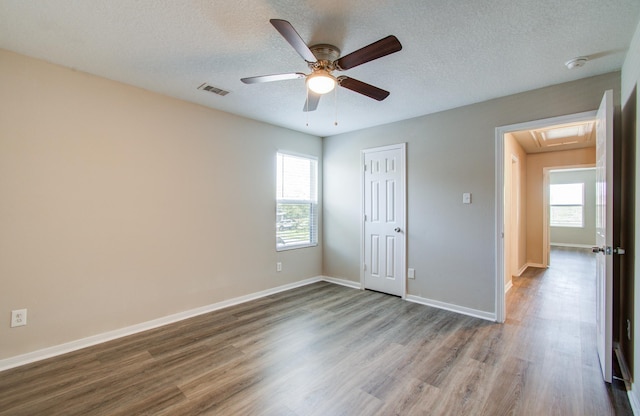 1211 Reedpoint Dr, Houston, TX 77090 - spare room with plenty of natural light, a ceiling fan, wood finished floors, and visible vents