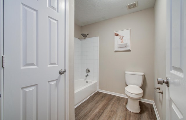 1211 Reedpoint Dr, Houston, TX 77090 - bathroom with visible vents, wood finished floors, toilet, baseboards, and a textured ceiling