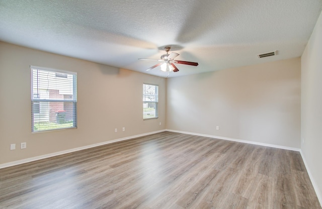 1211 Reedpoint Dr, Houston, TX 77090 - spare room with a textured ceiling, a ceiling fan, baseboards, wood finished floors, and visible vents